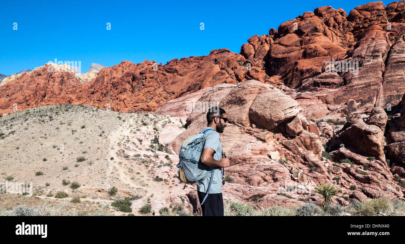 Rock climber hikes in Red Rock Canyon National Conservation Area, which is about 20 miles from Las Vegas Stock Photo