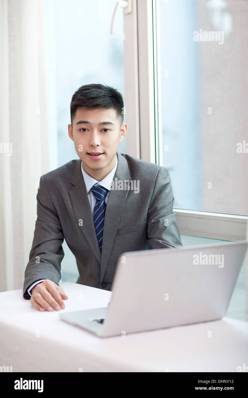 Businessman sitting by a laptop Stock Photo