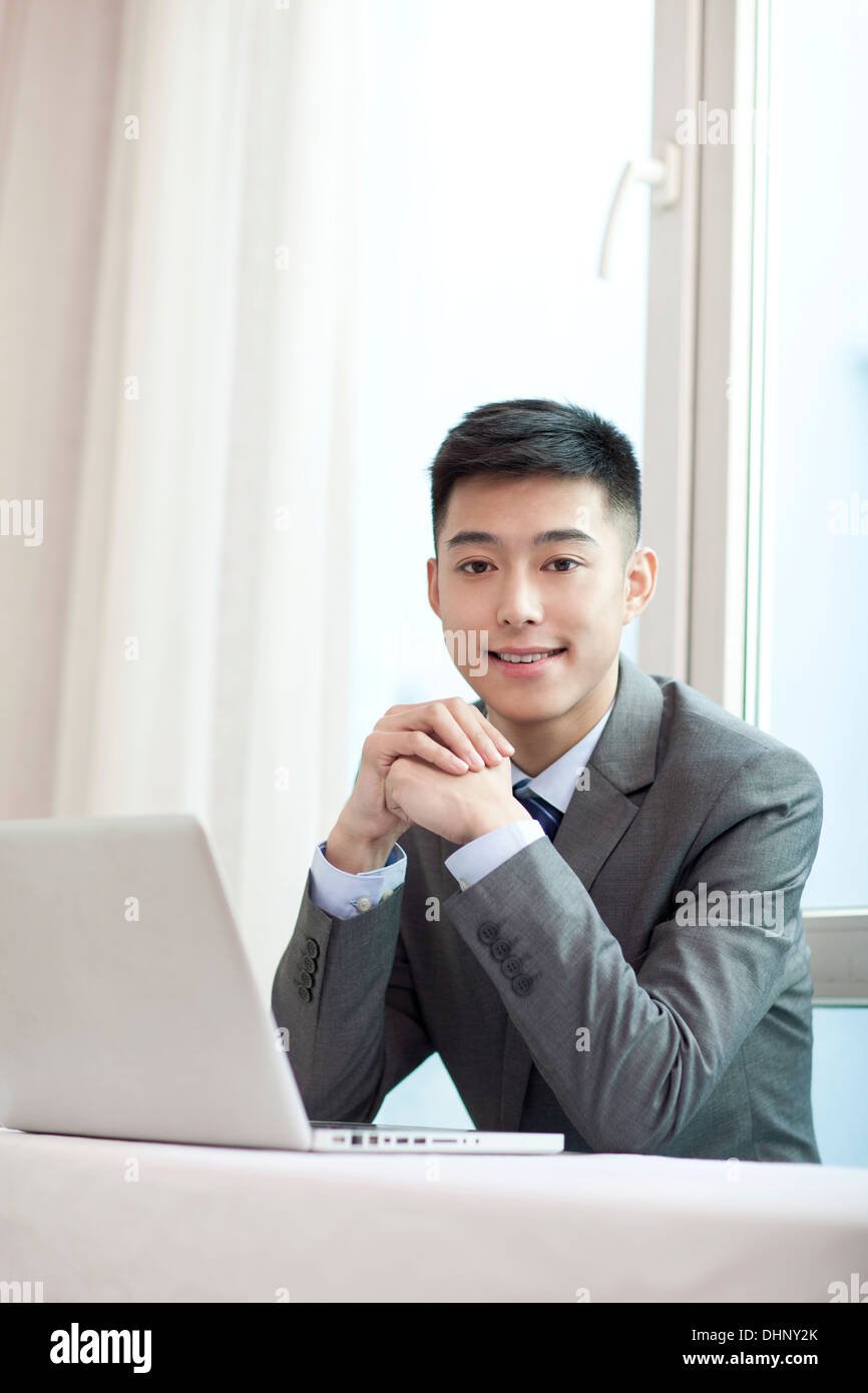Businessman sitting by a laptop Stock Photo