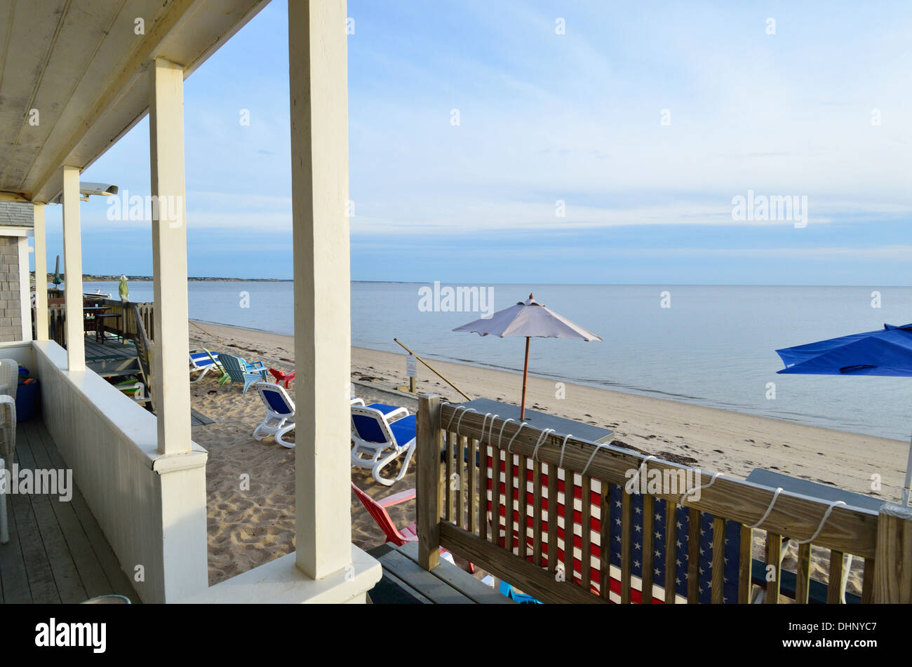 Ocean beach view  with colorful beach umbrellas from cottage porch of Cape Cod Bay in Truro, Cape Cod, Massachusetts. USA Stock Photo