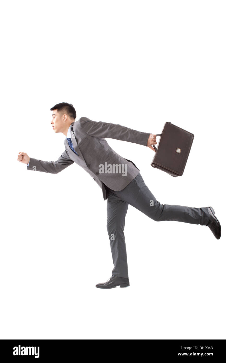 Young businessman holding briefcase and running Stock Photo