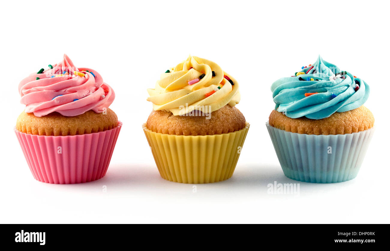 Three colorful frosted cupcakes with sprinkles on white background Stock Photo