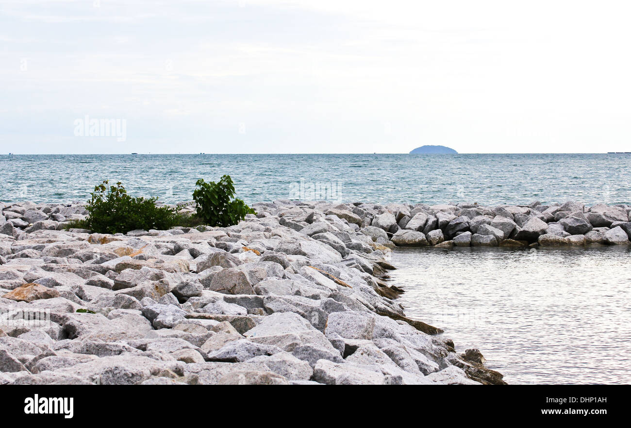 Breakwall rocks at sea coast in Thailand. Stock Photo