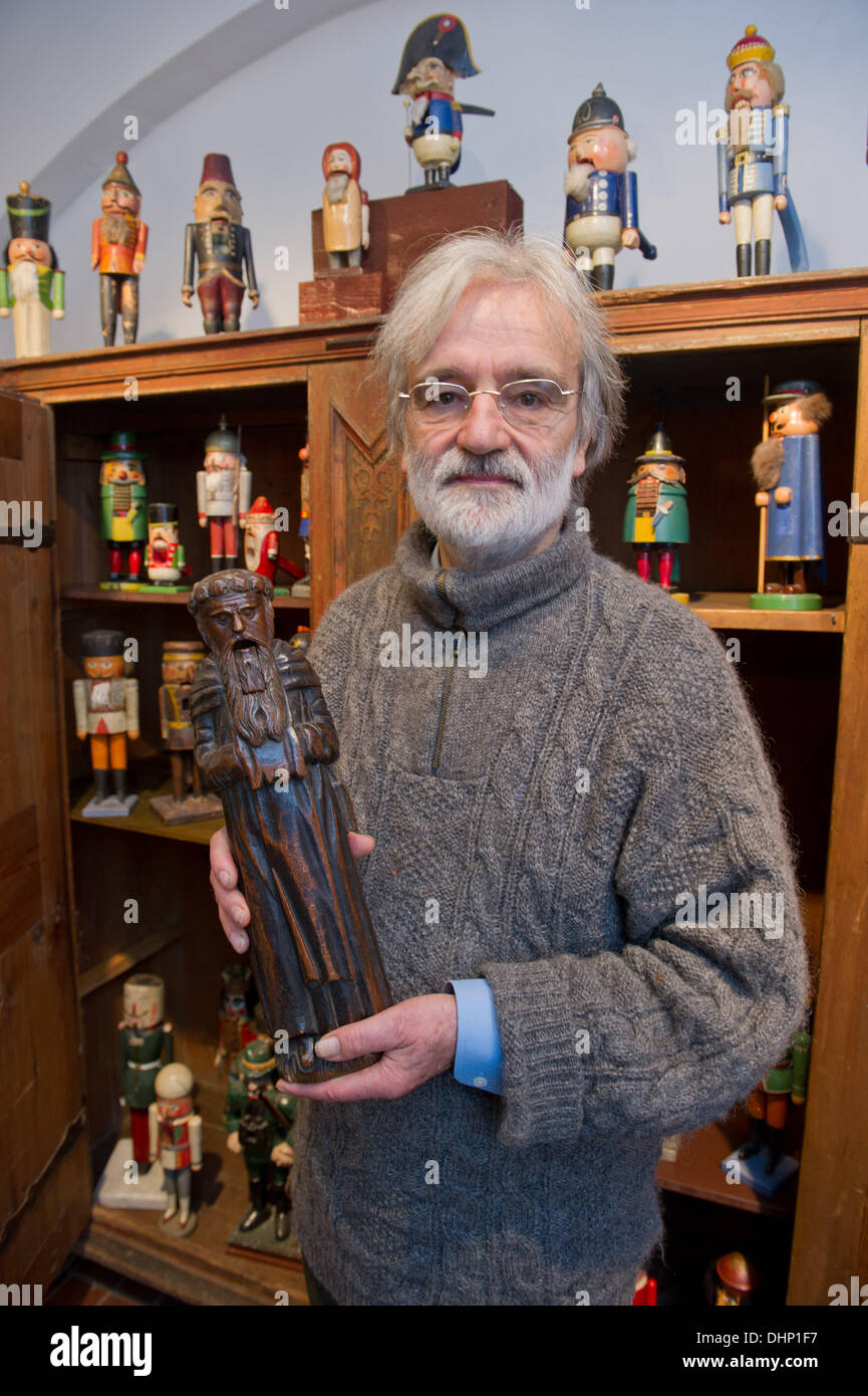 Stralsund, Germany. 12th Nov, 2013. The nutcracker collector from Bavaria, Adolf Heidenreich, shows a nutcracker as a monk figure from 1742 in Stralsund, Germany, 12 November 2013. From 15 November 2013, the Kulturhistorisches Museum of Stralsund exhibits the most beautiful pieces of his collection of about 150 nutcrackers. Photo: Stefan Sauer/dpa/Alamy Live News Stock Photo