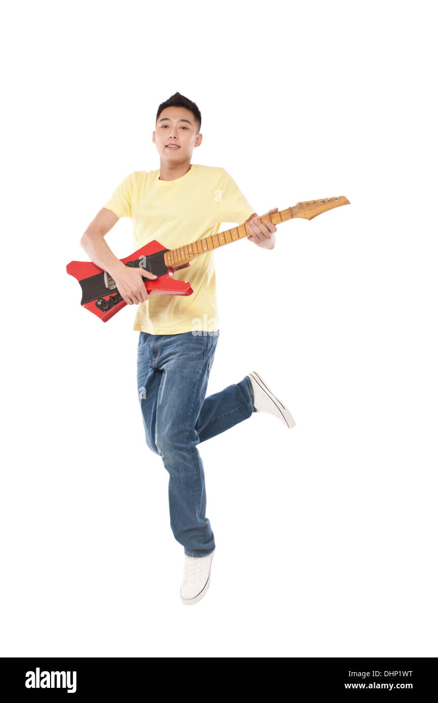Man holding a electric guitar on shoulder Stock Photo