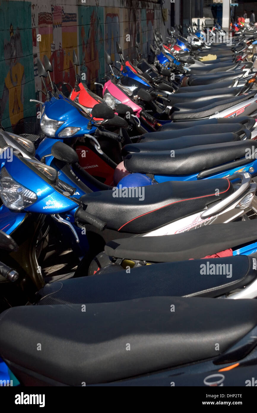 A group of motorcycles are parked on a city street in Khon Kaen, Thailand. Stock Photo