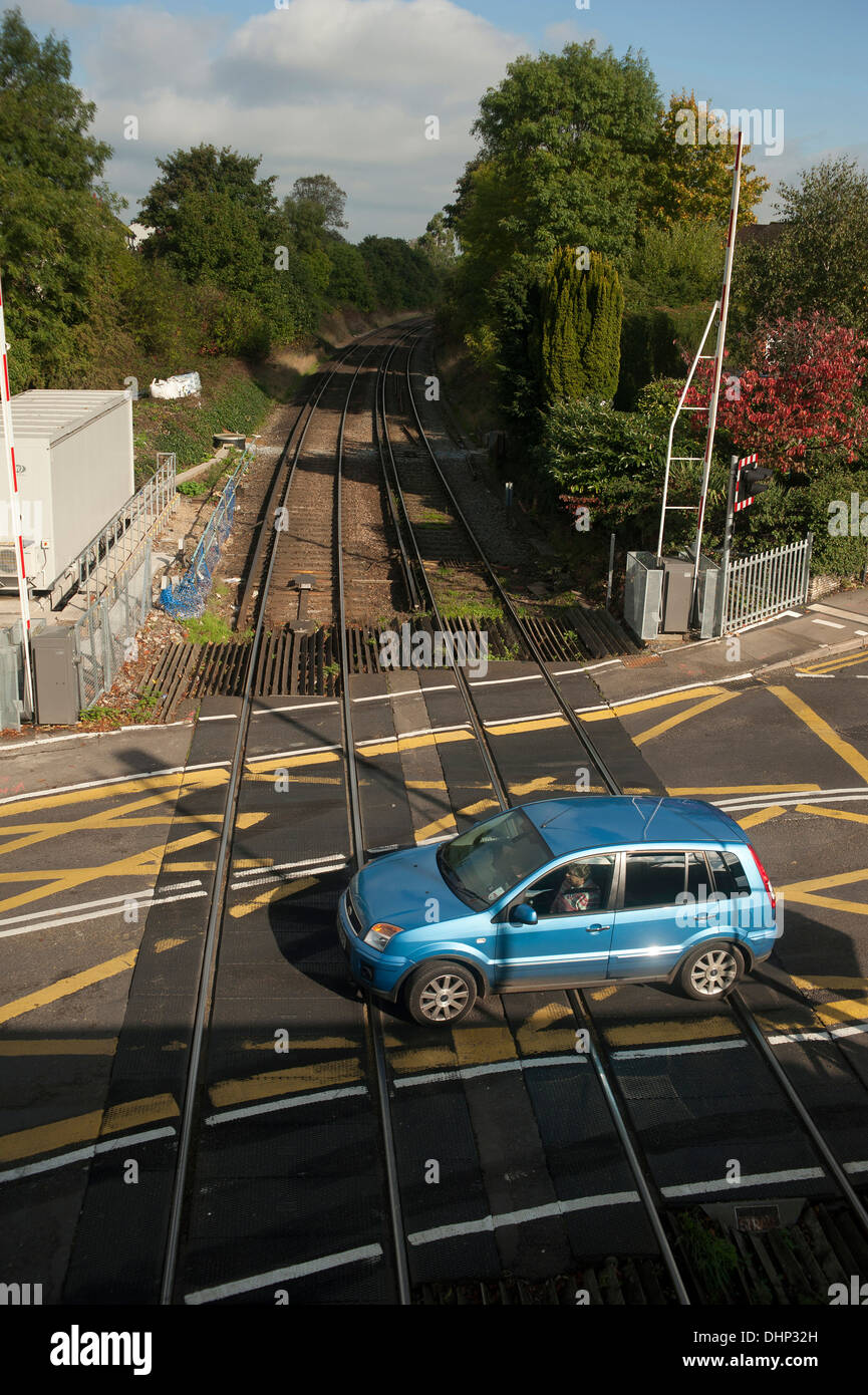 Car crosses the level crossing at Farnham train station, Surrey