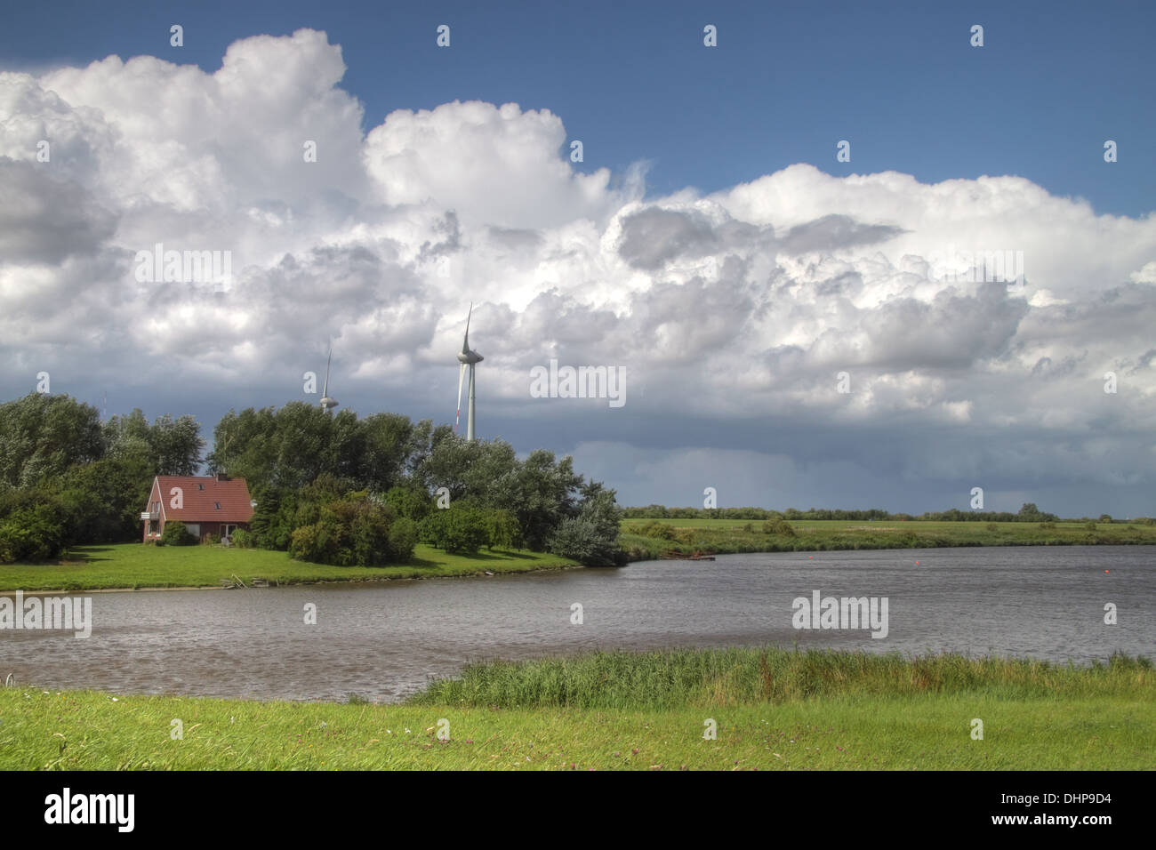 Farm and wind turbine in East Frisia Stock Photo