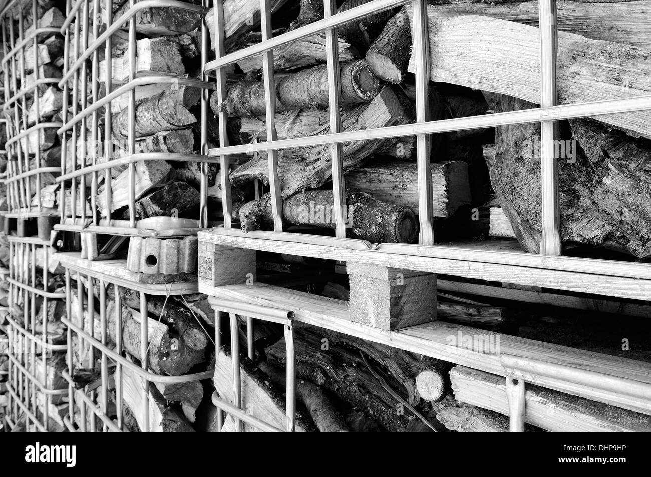 Firewood in grid boxes black and white Stock Photo