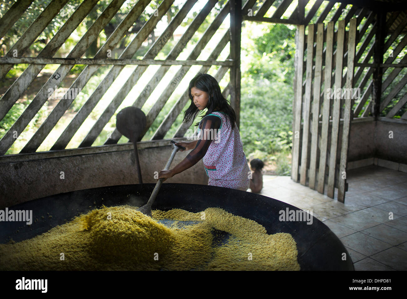 May 6, 2013 - Poti-Kro, Para, Brazil - Yucca is a staple food for the Xikrin. Here, grated yucca is roasted to make farinha, which accompanies almost every meal. The indigenous Xikrin people live on the Bacaja, a tributary of the Xingu River, where construction of the Belo Monte Dam is reaching peak construction. Some scientists warn that the water level of the Bacaja will decrease precipitously due to the dam. (Credit Image: © Taylor Weidman/ZUMA Wire/ZUMAPRESS.com) Stock Photo