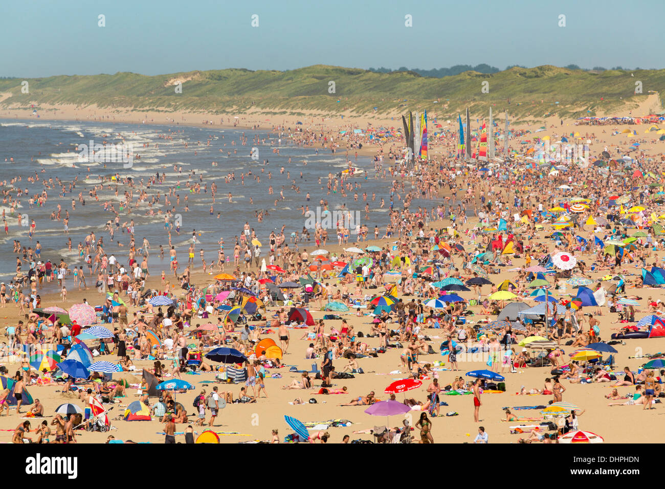 Netherlands, Scheveningen, near The Hague. Summertime on crowded beach. People enjoying sun and sea water. Aerial view. Stock Photo