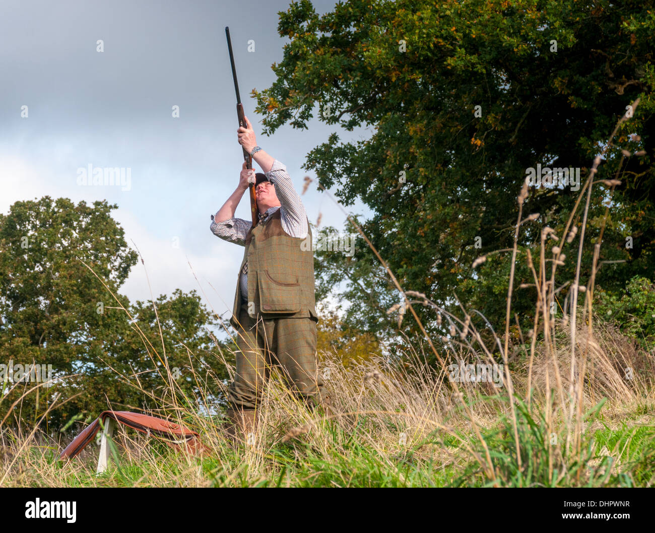 A man, often called a Gun, with a shotgun on a pheasant shoot in England Stock Photo