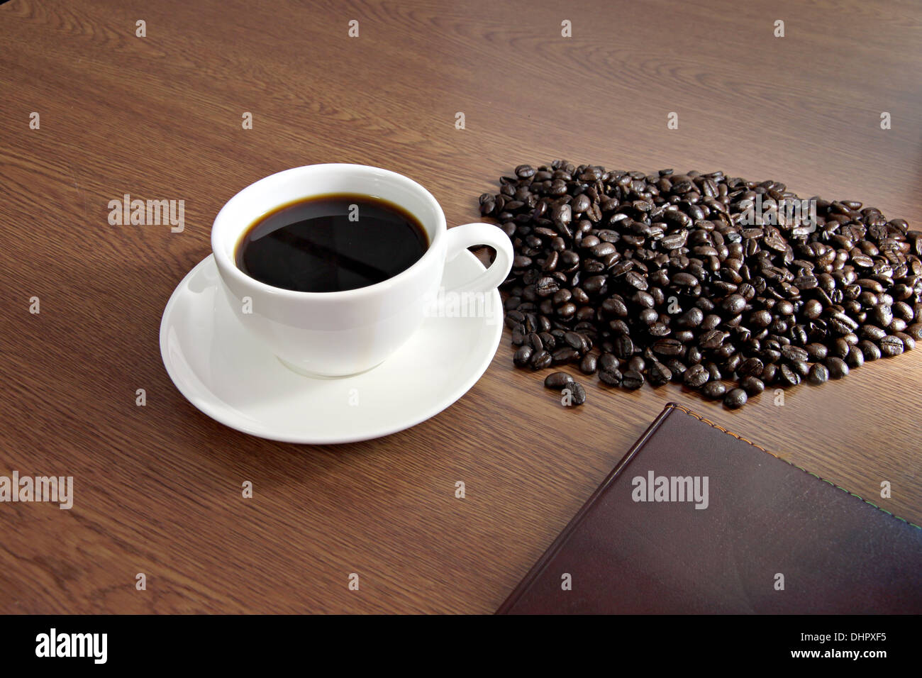 Focus picture Coffee in white cup and a seed is placed nearby Stock