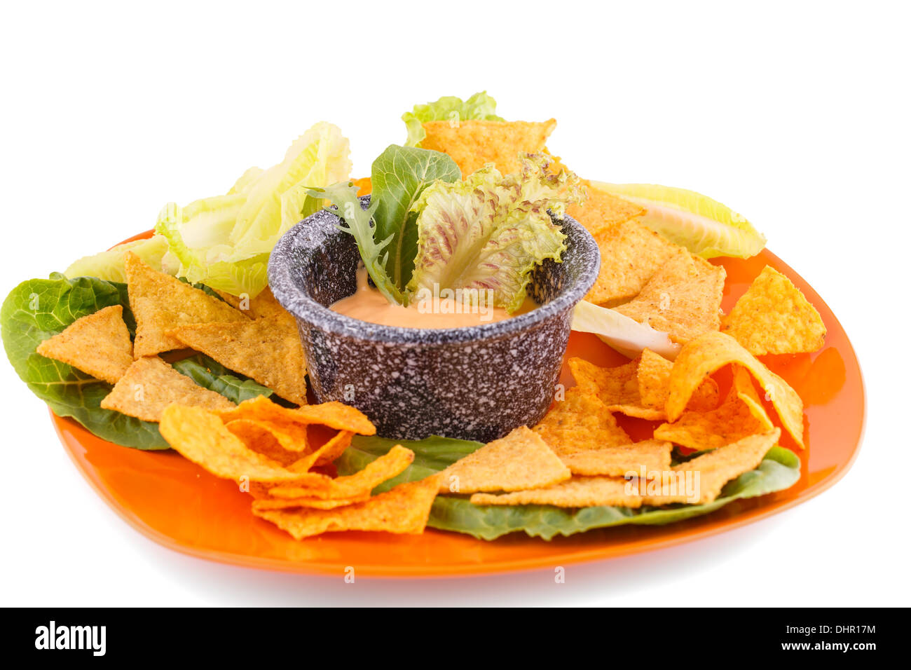 Nachos, lettuce and cheese sauce isolated on white background Stock