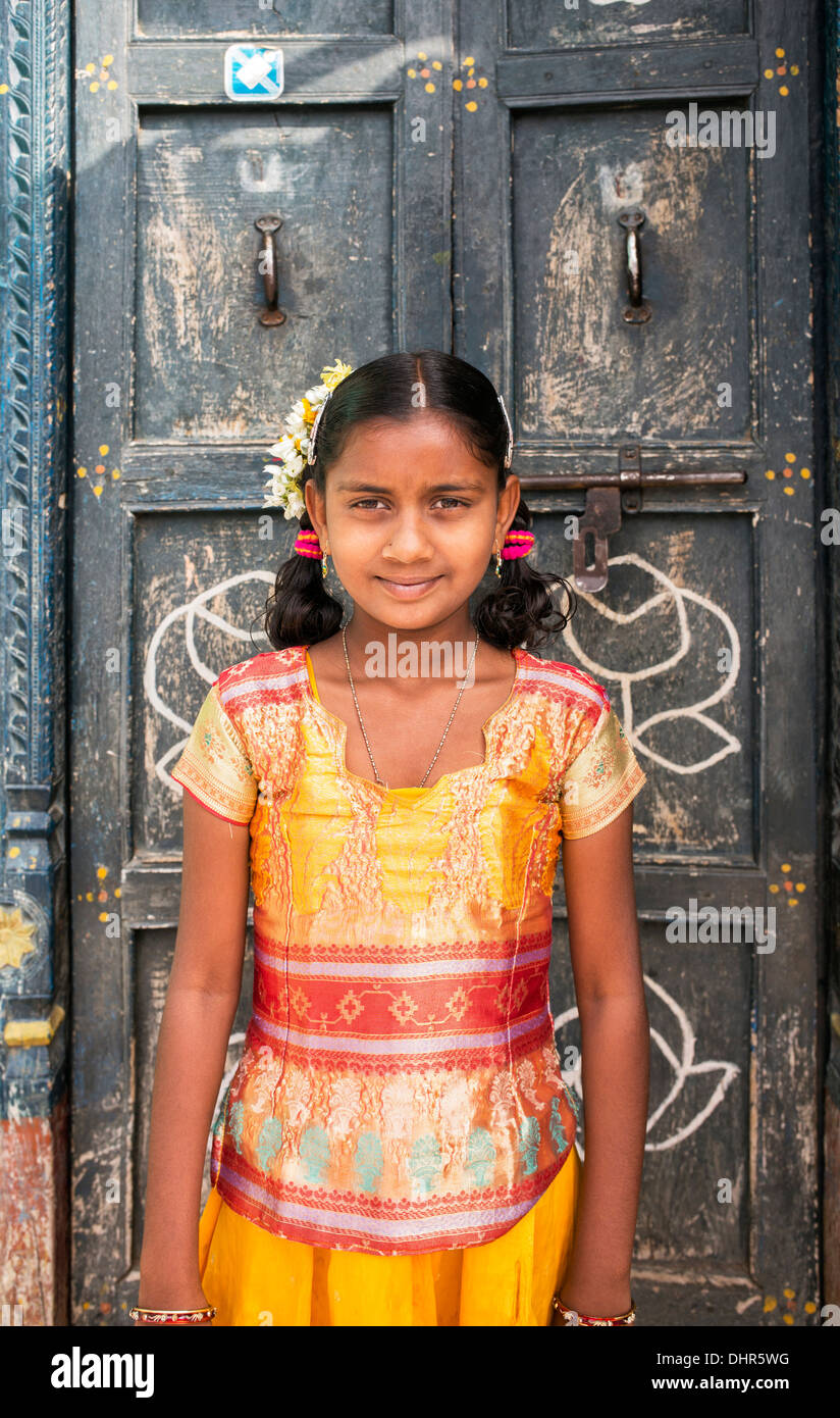 LITTLE GIRL STANDING IN THE DOORWAY TYPICAL NEPALESE BRASS-STUDDED