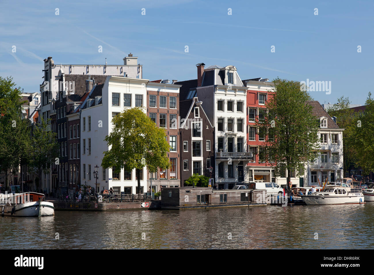 Houseboats in the canal in Amsterdam and Duch townhouses Stock Photo