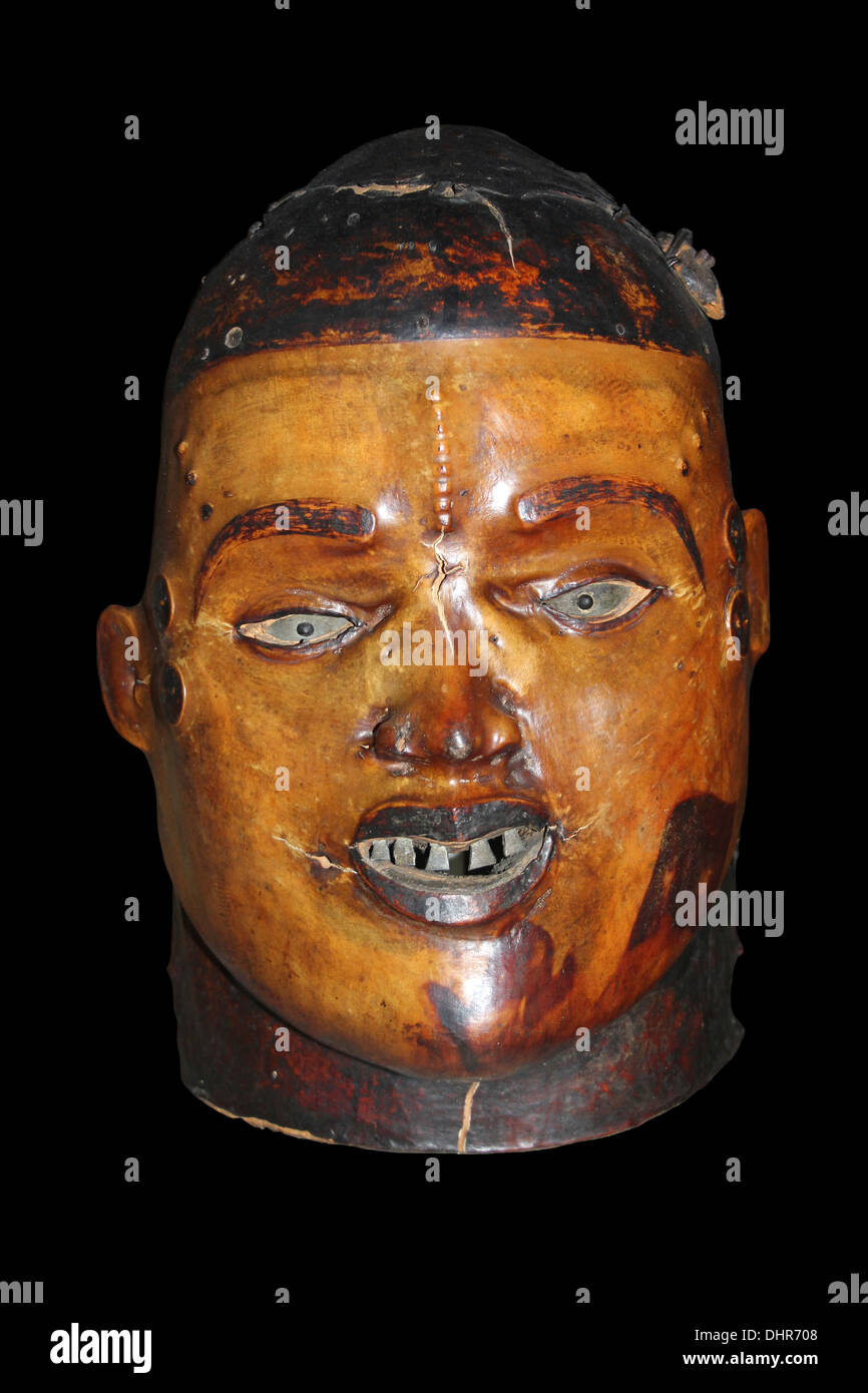 Helmet Mask - cut from wood and covered with pigskin with teeth inlaid with metal Stock Photo