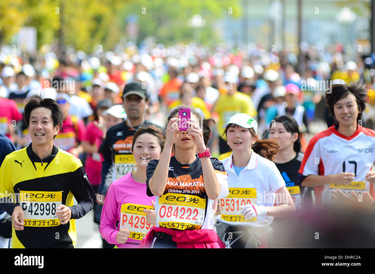 A runner taking a photograph during a marathon in Osaka, Japan. Stock Photo