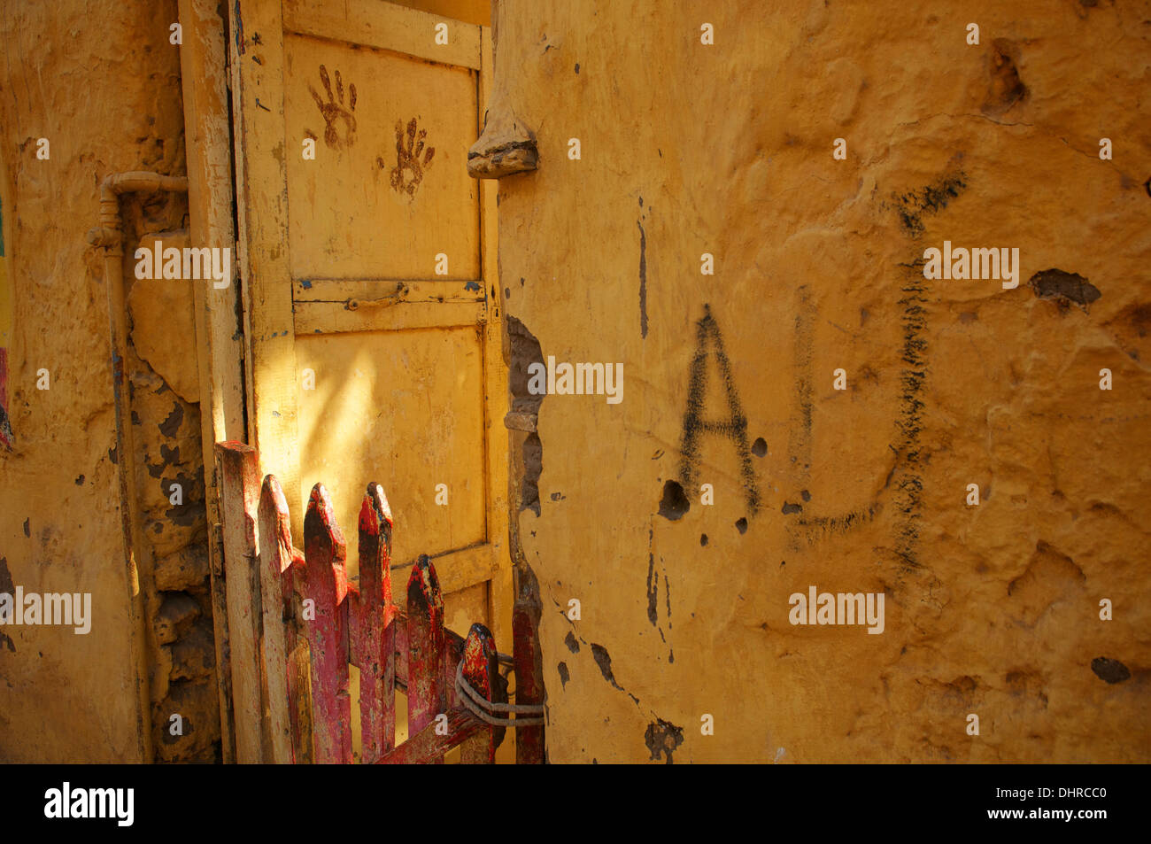 Painted wall and gate before a house in the village of Siou on the island of Elephantine at Aswan, Egypt. Stock Photo