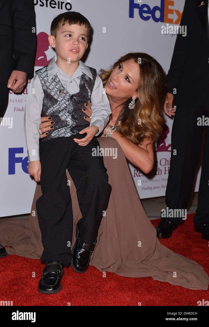 Daisy Fuentes poses with a child The St. Jude Angels & Stars Gala at JW