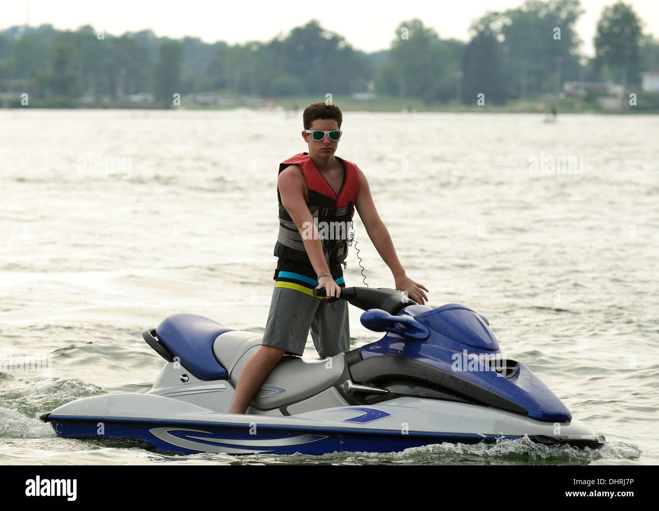 Teen boy on personal watercraft on a lake. Stock Photo