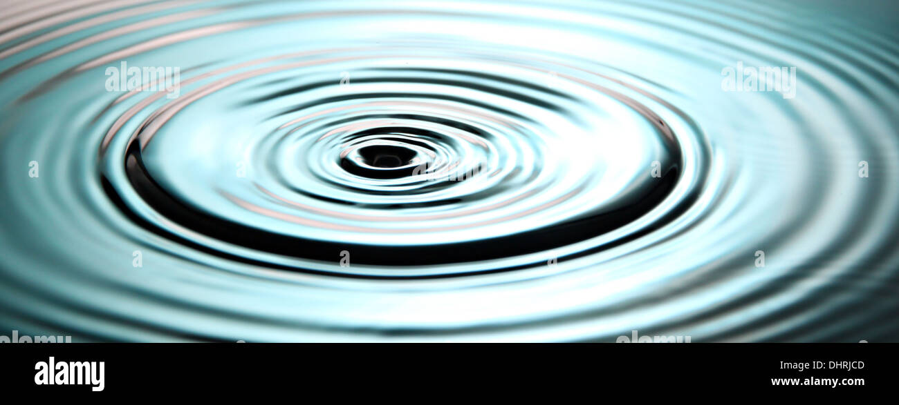 Closeup Pictures Blue Background of Ripple Water drops in Basin. Stock Photo