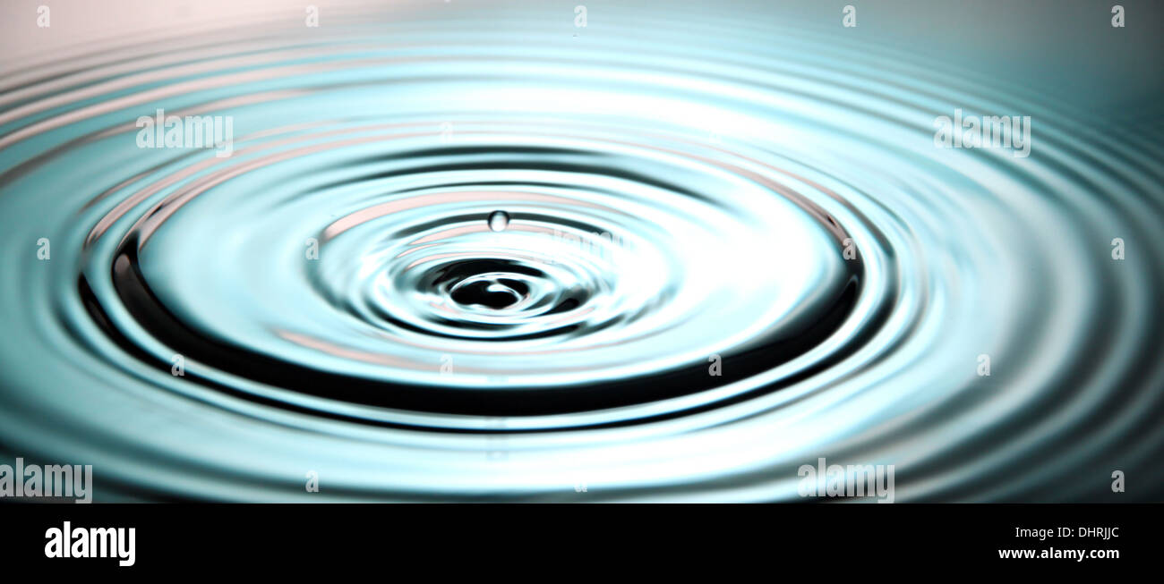 Closeup Pictures Blue Background of Ripple Water drops in Basin. Stock Photo