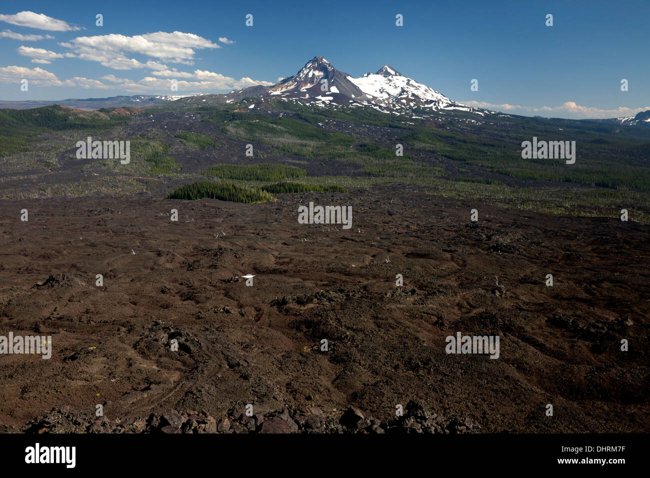 The Lava Flow north of McKenzie Pass and the North and Middle Sisters from the summit of Little Belknap Crater near the PCT. Stock Photo