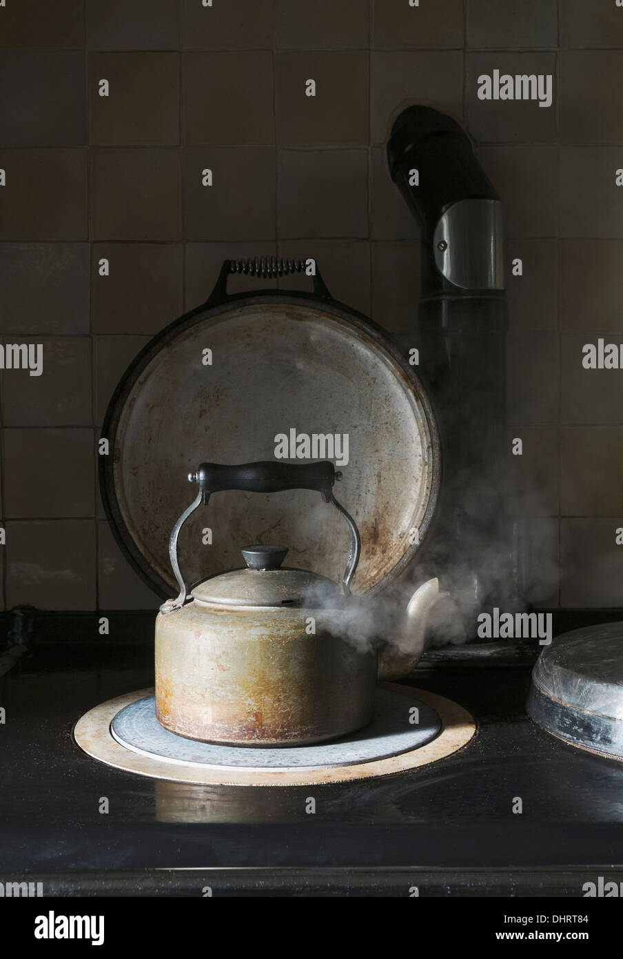 Kettle boiling on cooking range Stock Photo