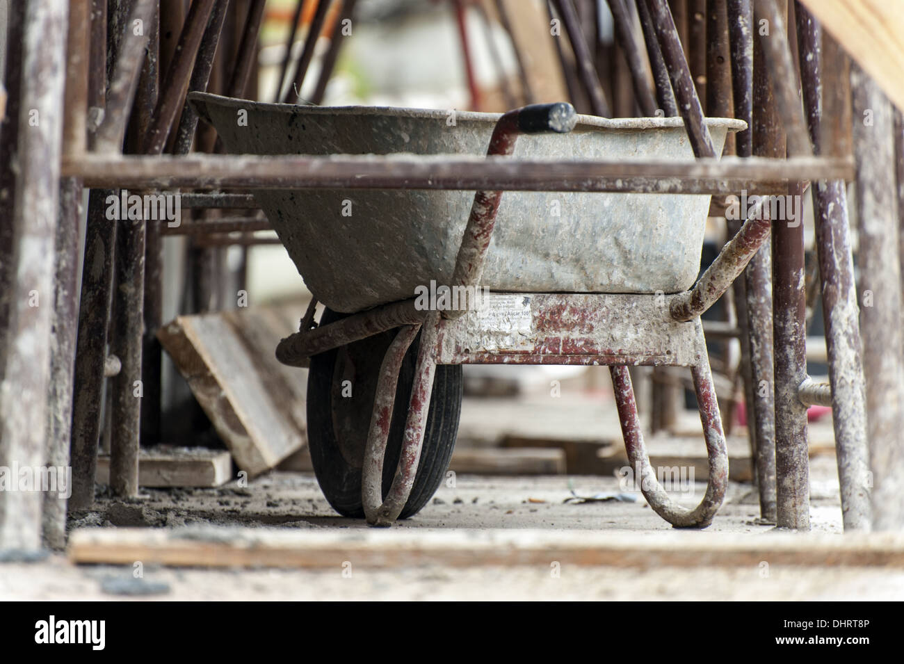 Wheelbarrow standing on a scaffold Stock Photo