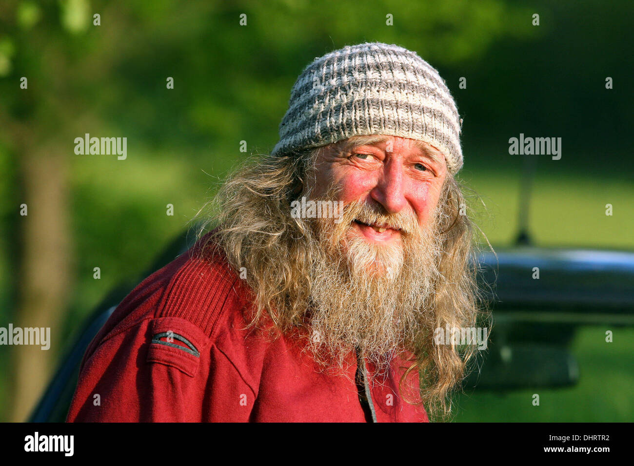 Senior man portrait Old hipster man with long hair and beard in a cap, 60s Stock Photo