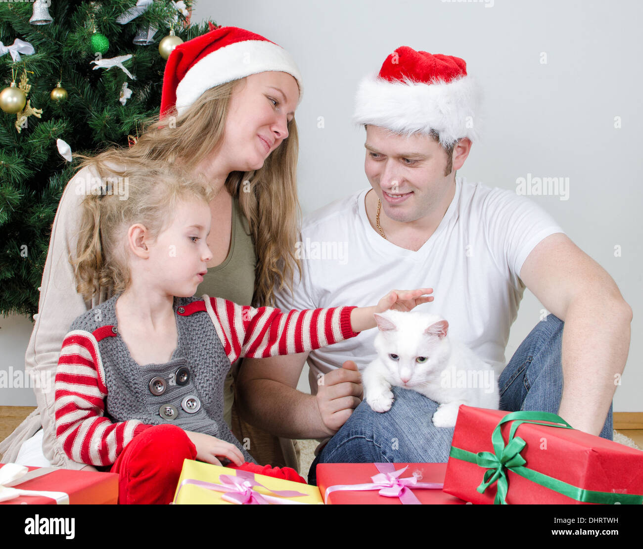 Happy family portrait in front of christmas tree. Stock Photo