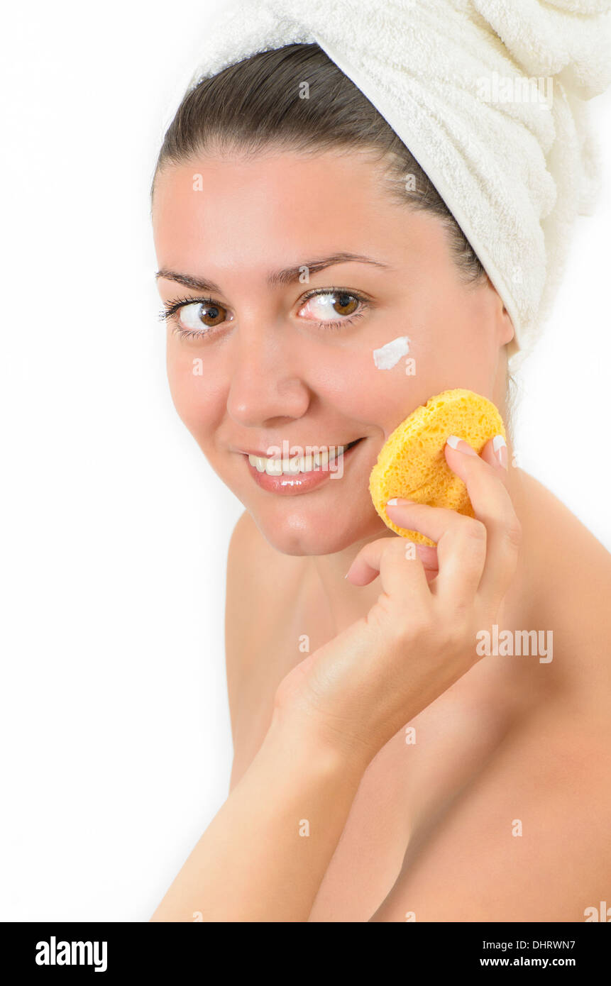 Young beautiful woman cleansing her skin Stock Photo