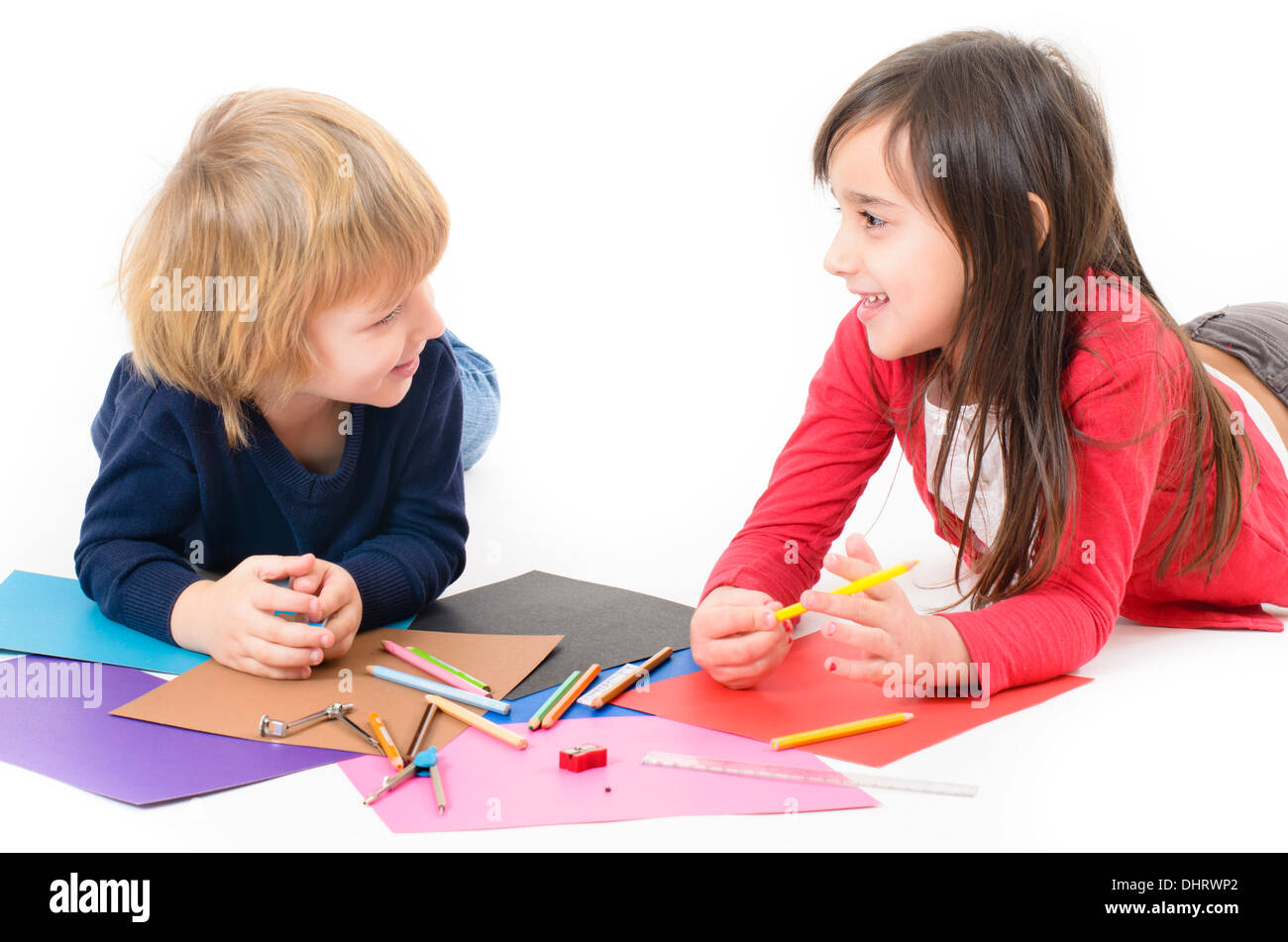 Two happy children doing homework Stock Photo