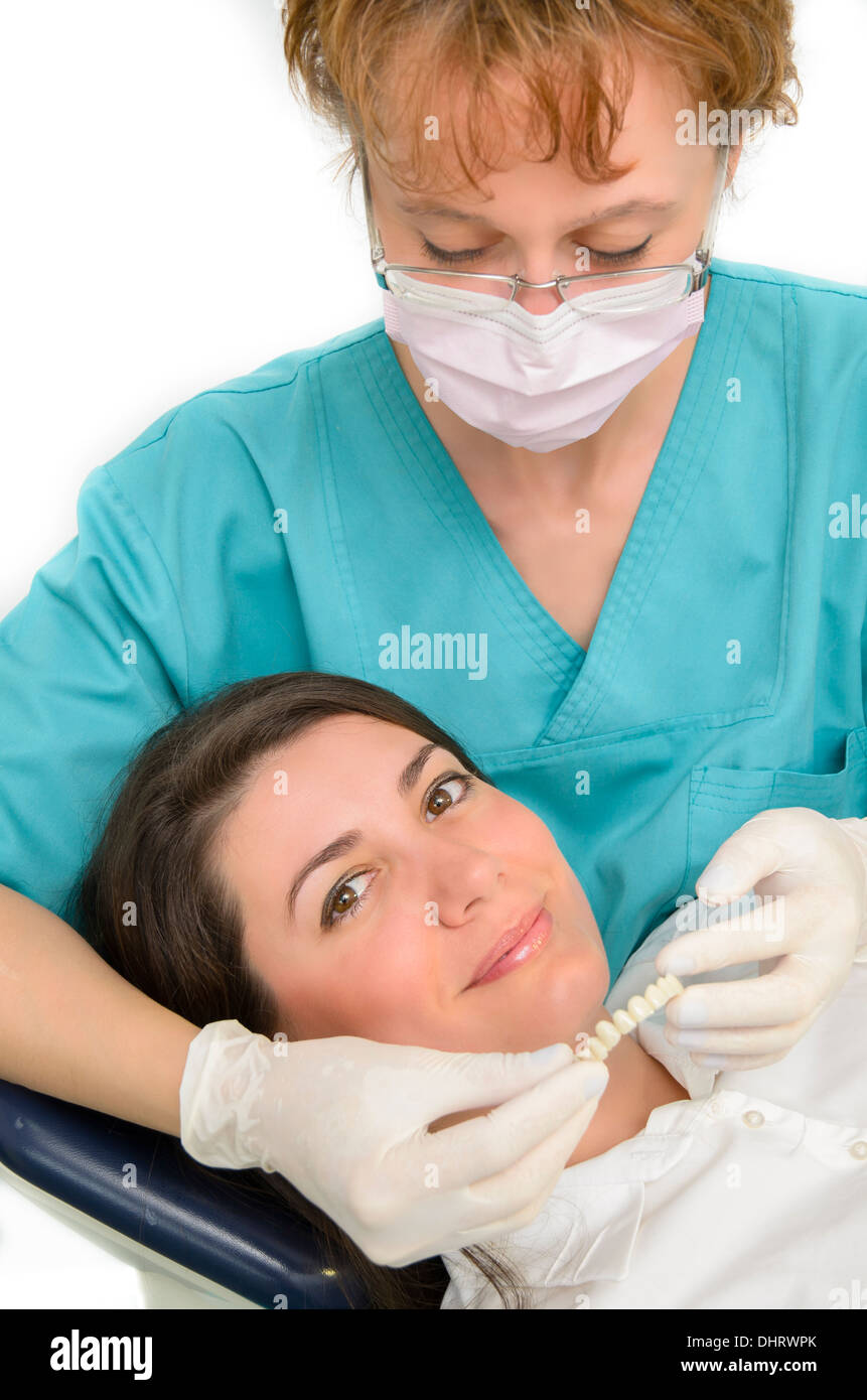 A dentist showing porcelain teeth to patient Stock Photo
