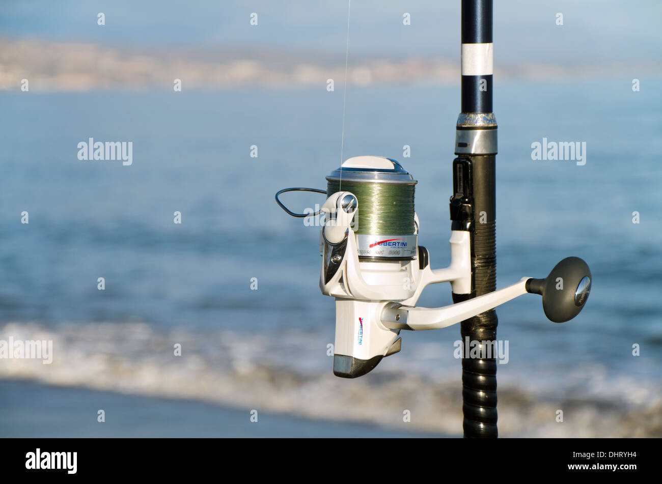 Detail of a fishing reel and rod with mediterranean sea in background. Malaga, Spain. Stock Photo
