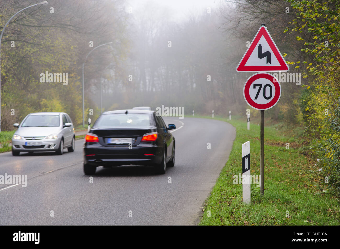 Traffic sign in front of a curve Stock Photo