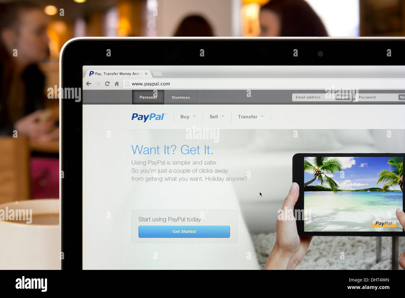 The PayPal website shot in a coffee shop environment (Editorial use only: print, TV, e-book and editorial website). Stock Photo
