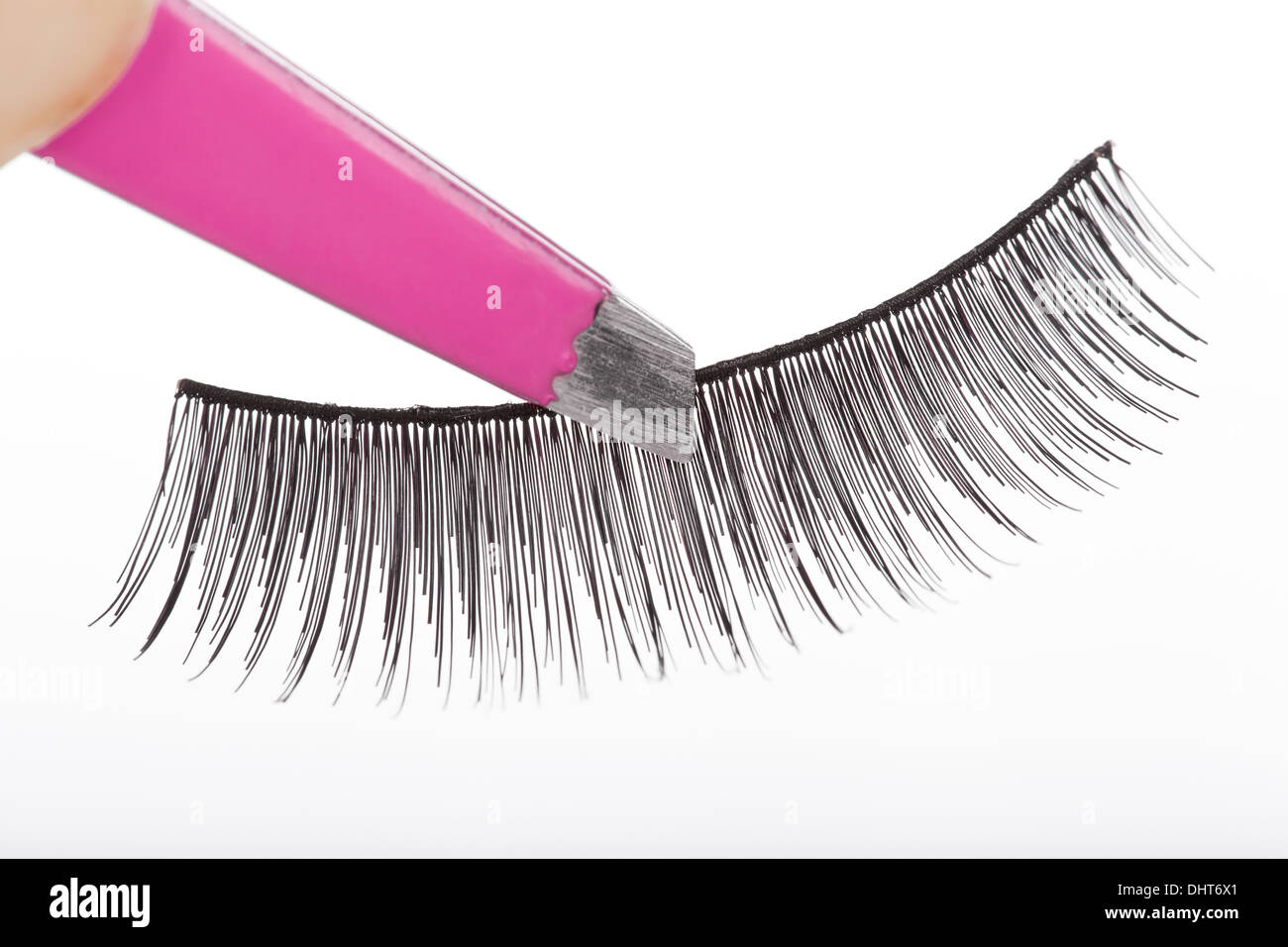 False lashes and pink pincers, closeup on white background  Stock Photo