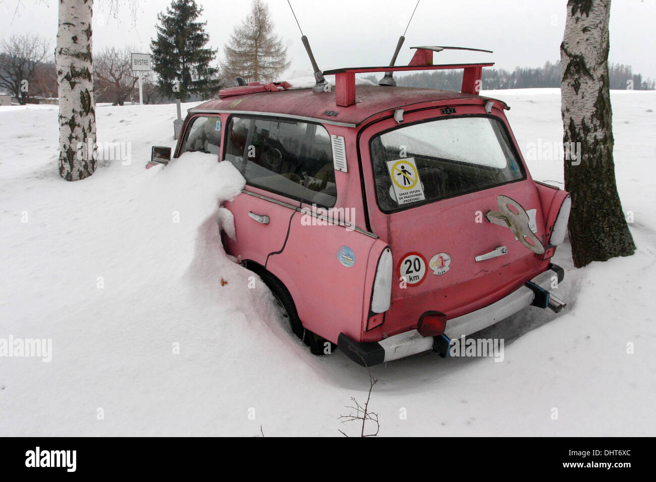 Snowy pink Trabant combi, car parked in snowdrift, Trabant in snow winter scene Stock Photo