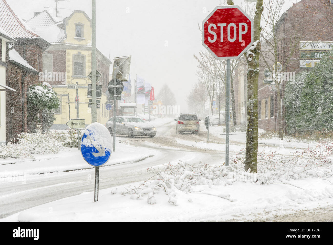 Stop sign on a snowy road crossing Stock Photo