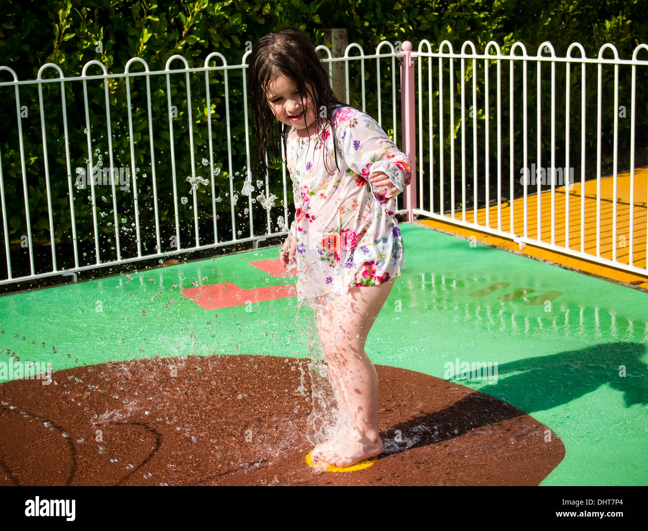 Girl playing in water fountain hi-res stock photography and images - Alamy