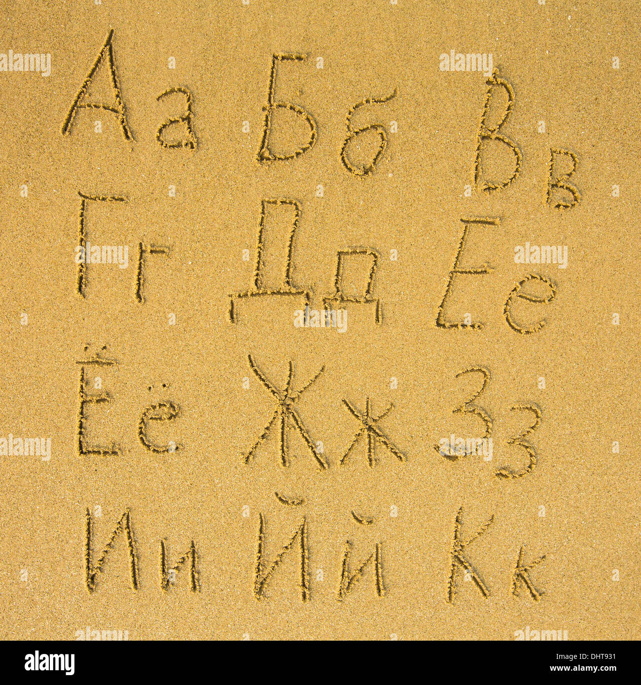 Russian alphabet (from A to K) written on a sand beach. Stock Photo