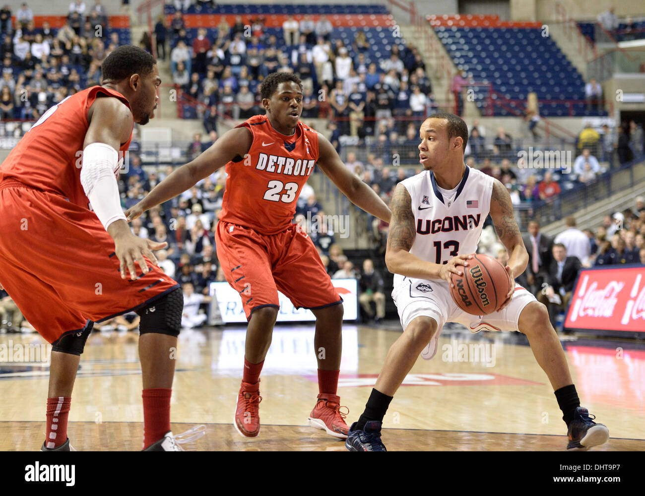 Storrs, CT, USA. 14th Nov, 2013. Thursday November 14, 2013: Connecticut Huskies guard Shabazz Napier (13) looks to pass the ball while being guarded by Detroit Titans center Ugochukwu Njoku (15) and Detroit Titans guard Carlton Brundidge (23) during the 1st half of the NCAA basketball game between Detroit and Connecticut at Gampel Pavilion in Storrs, CT. UConn went on to beat Detroit very easily 101-55. Bill Shettle / Cal Sport Media. Credit:  csm/Alamy Live News Stock Photo