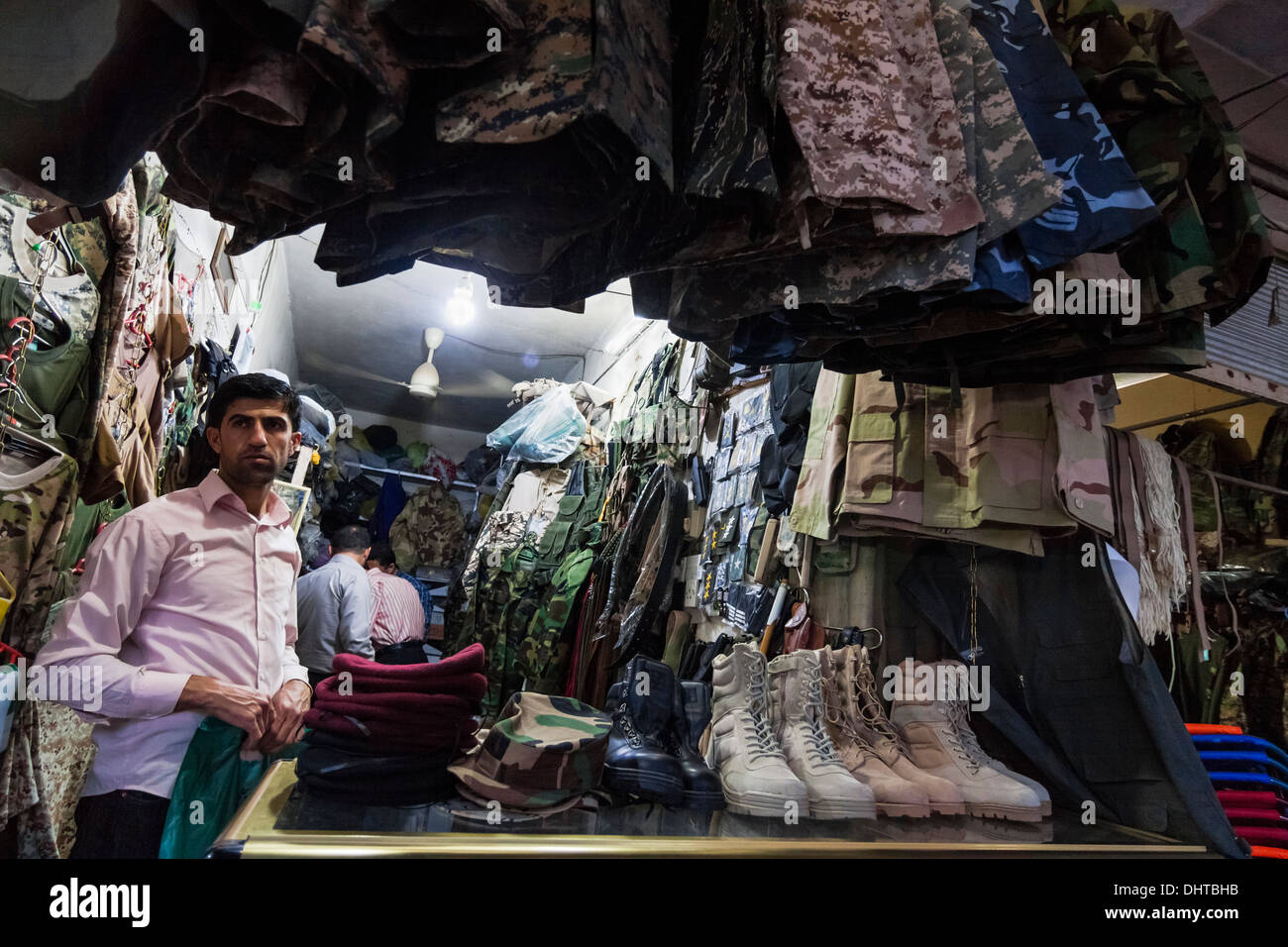 Vendor at bazaar shop selling military gear at Dohuk bazaar, Kurdish