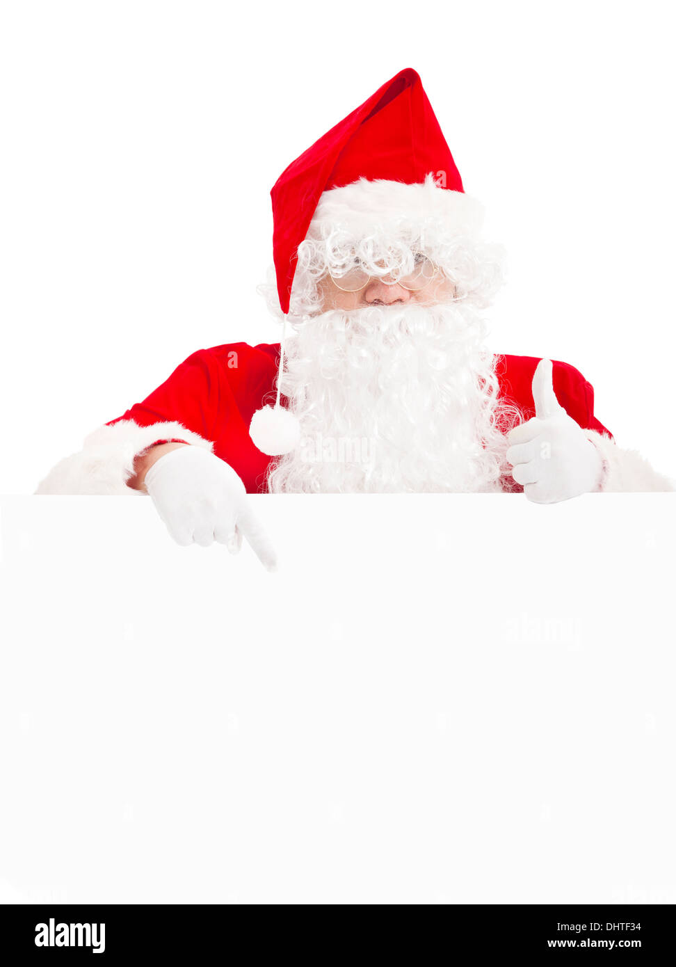 happy Santa Claus pointing at blank banner with thumb up Stock Photo