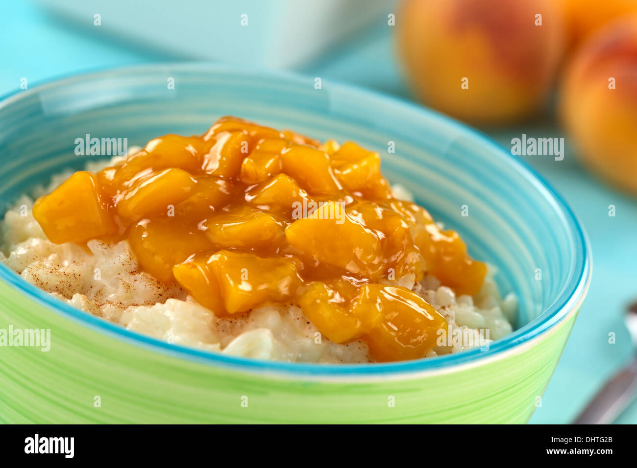 Colorful bowl full of fresh homemade rice pudding with peach compote
