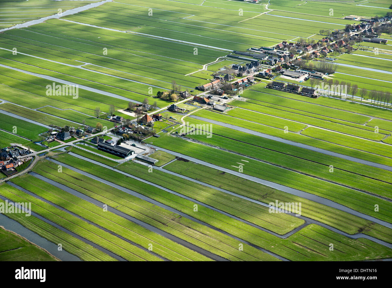 Netherlands, Den Ilp, Houses and farms in polder landscape. Aerial Stock Photo