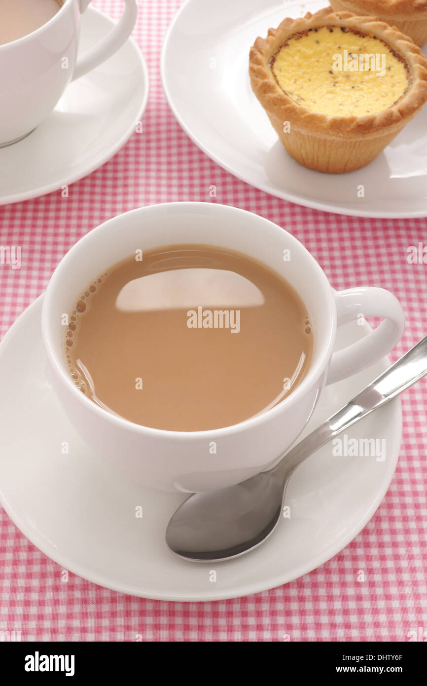 Tea served with milk in a white tea service Stock Photo