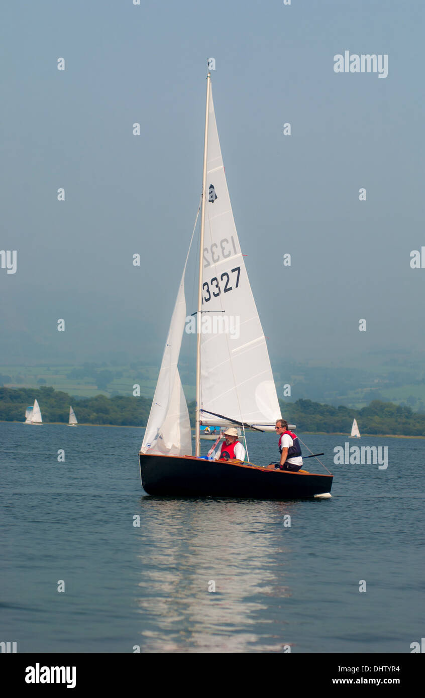 White sailed GP14 sailing dinghy at Bassenthwaite Lake, Cumbria, UK. Stock Photo